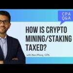 How does the tax system address cryptocurrency mining and staking?